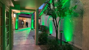 Walkway, exterior, decorative walkway lined with shrubbery and green up-lighting leading to the banquet entrance