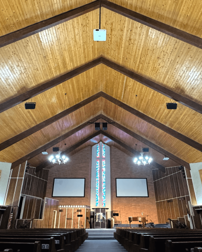 Church, interior, speakers hanging from high wooden ceiling